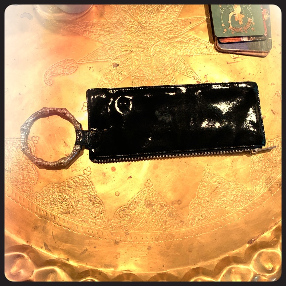 Trina Turk black patent wristlet